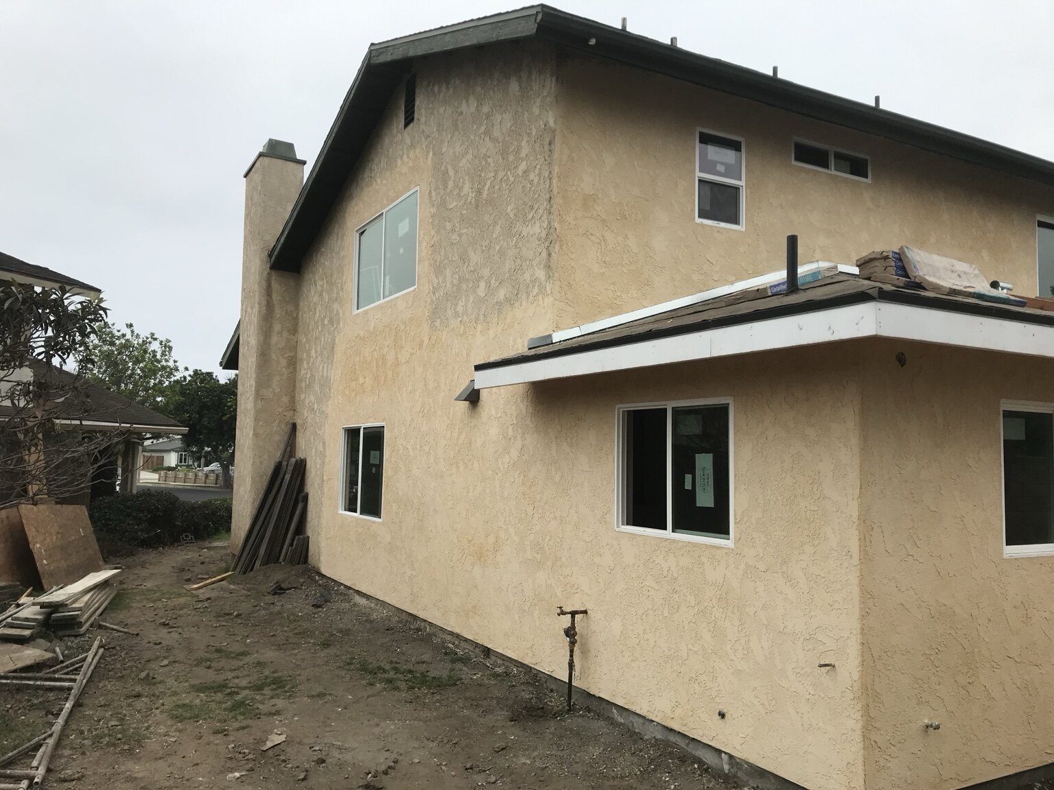 Exterior stucco work in progress on a major home addition