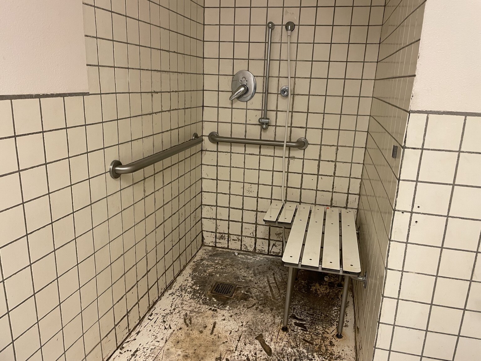 Existing commercial shower before accessibility improvements