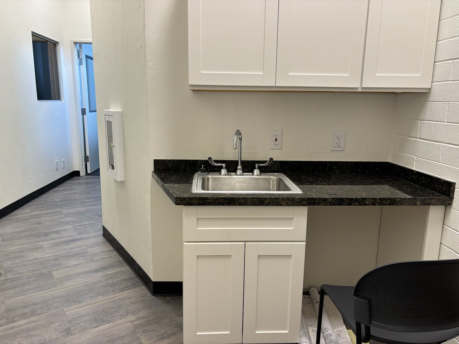 Completed commercial kitchenette with cabinetry and appliances